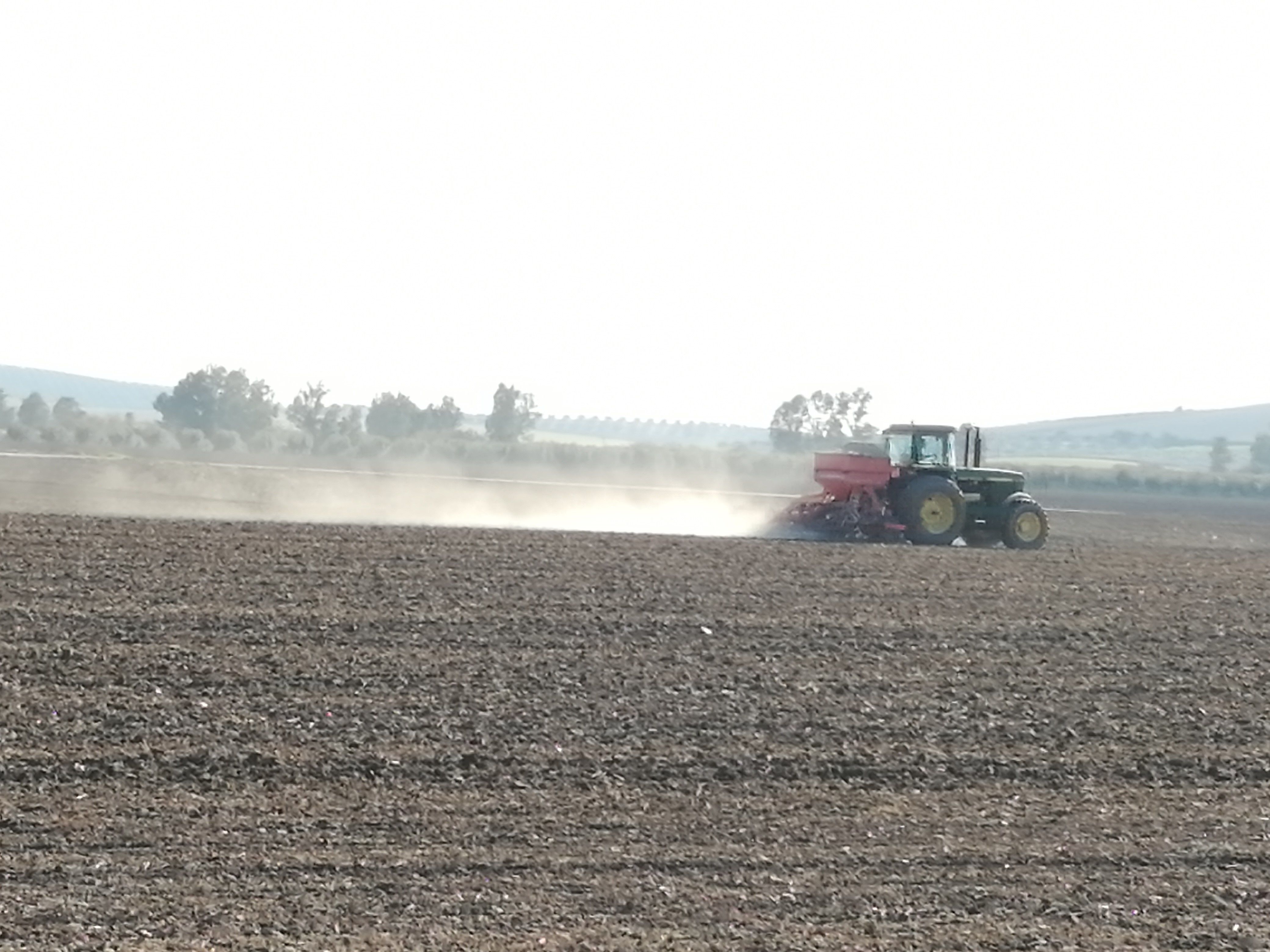  Un agricultor trabaja con su tractor en el campo. Foto de archivo